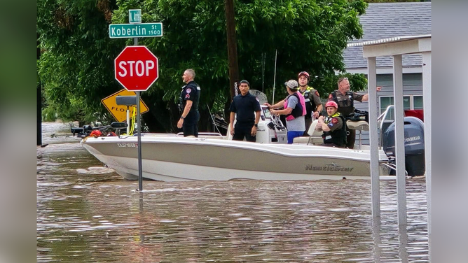 First responders take a boat onto floodwaters in San Angelo, Texas, on Friday morning.